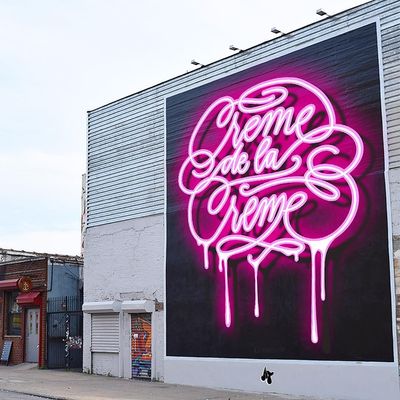 a large pink neon sign on the side of a building