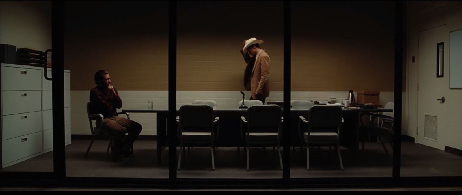 two people sitting at a table in a room