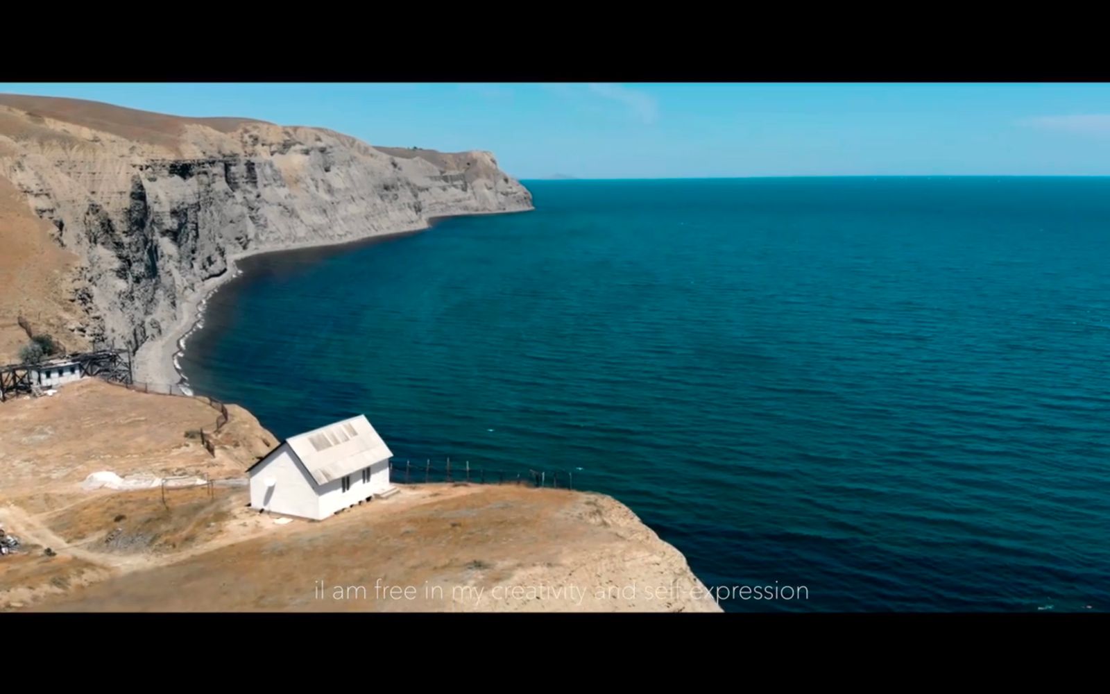 a house on a cliff overlooking a body of water