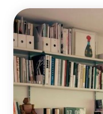 a bookshelf filled with lots of books next to a window