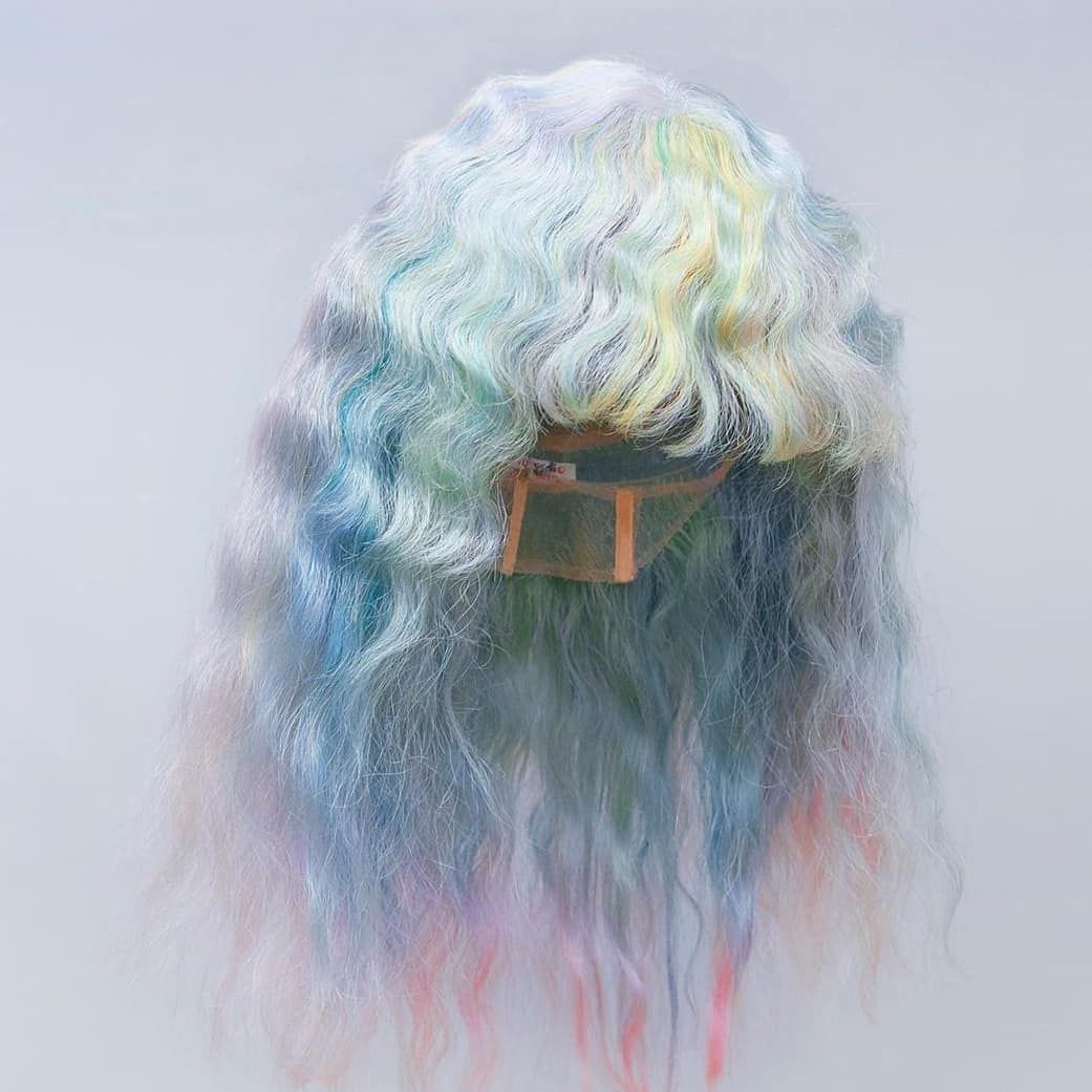 a wig with multicolored hair and a leather belt