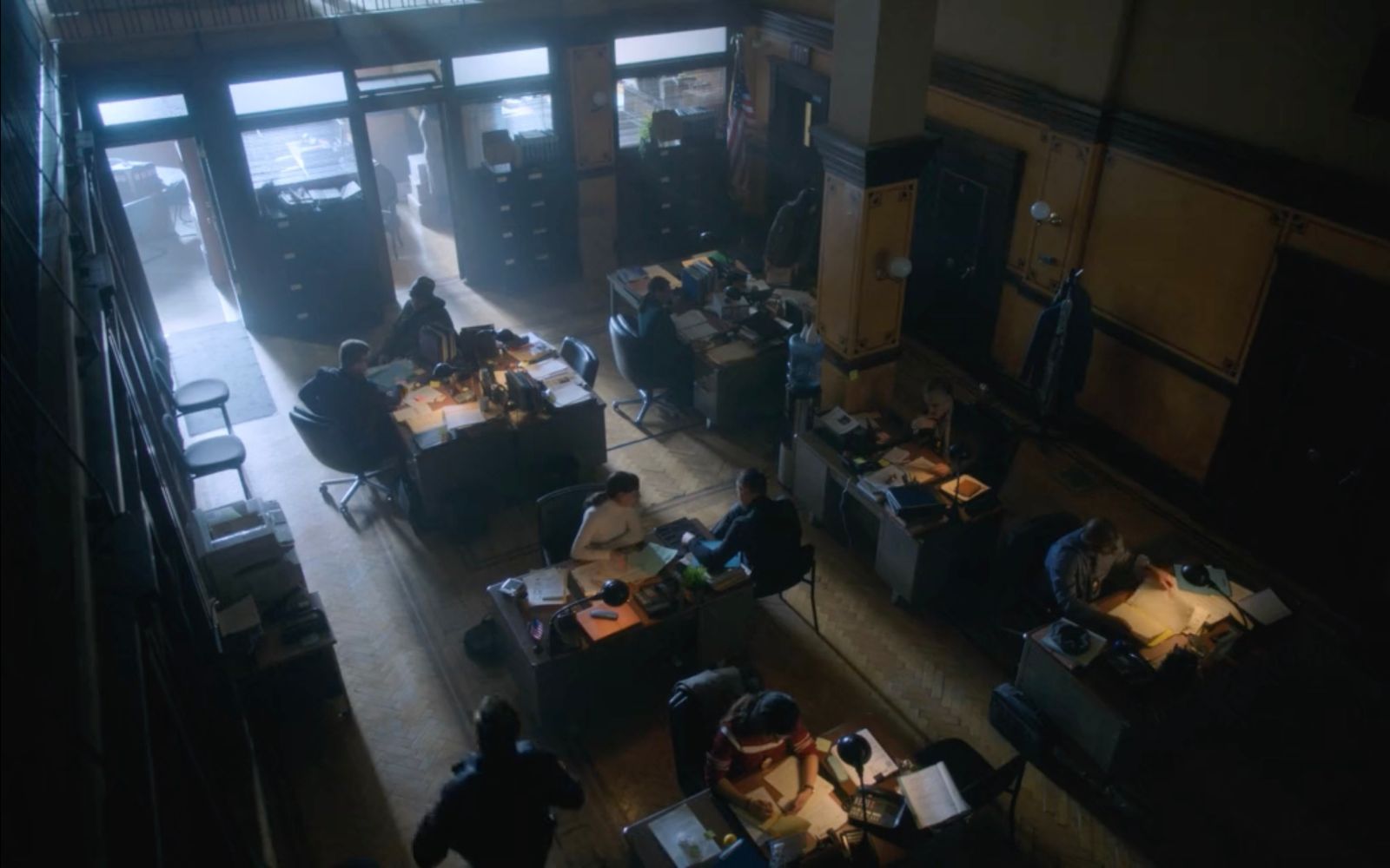 a group of people sitting at desks in a room