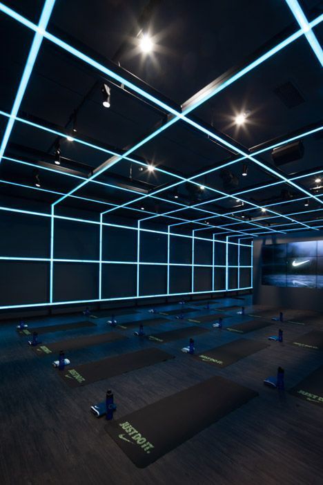 a dark room with blue lights and yoga mats