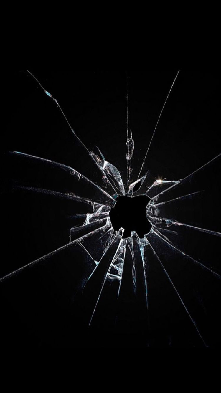 a broken glass window in the dark