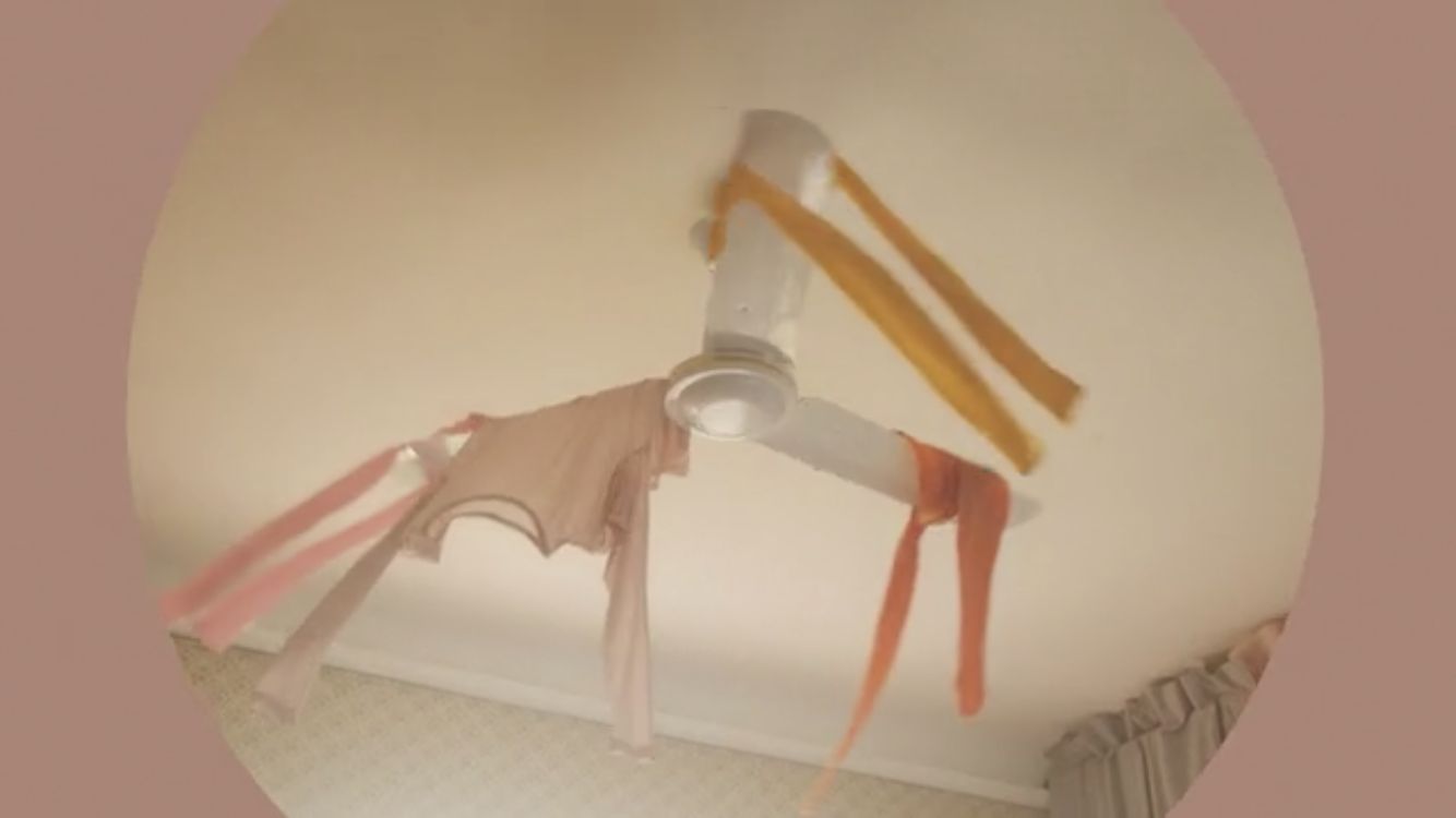 a mirror image of clothes hanging from a ceiling