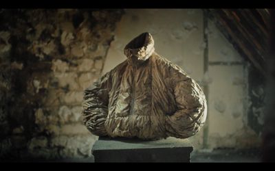 a statue of a person wearing a jacket