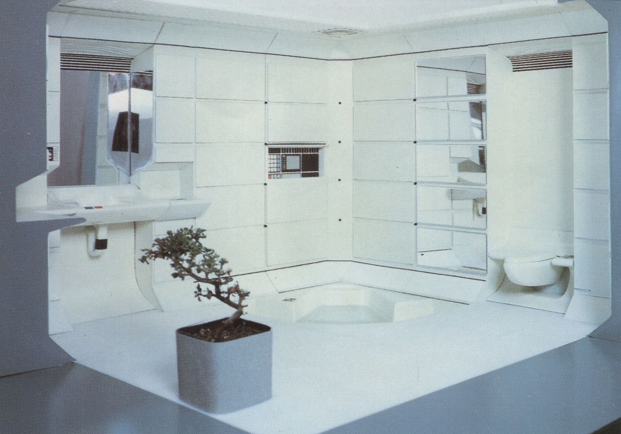 a white bathroom with a potted plant in the corner