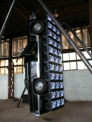 a large stack of televisions sitting inside of a building