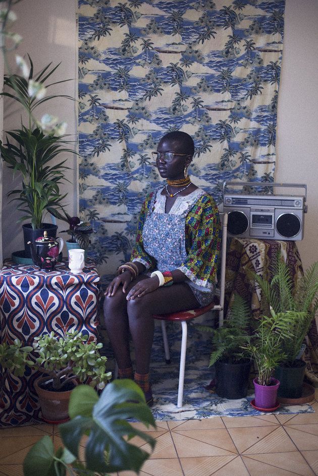 a woman sitting in a chair next to a table