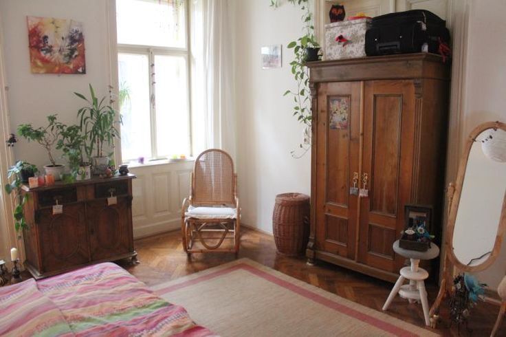 a bedroom with a bed, dresser and mirror