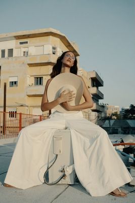 a woman sitting on top of a suitcase