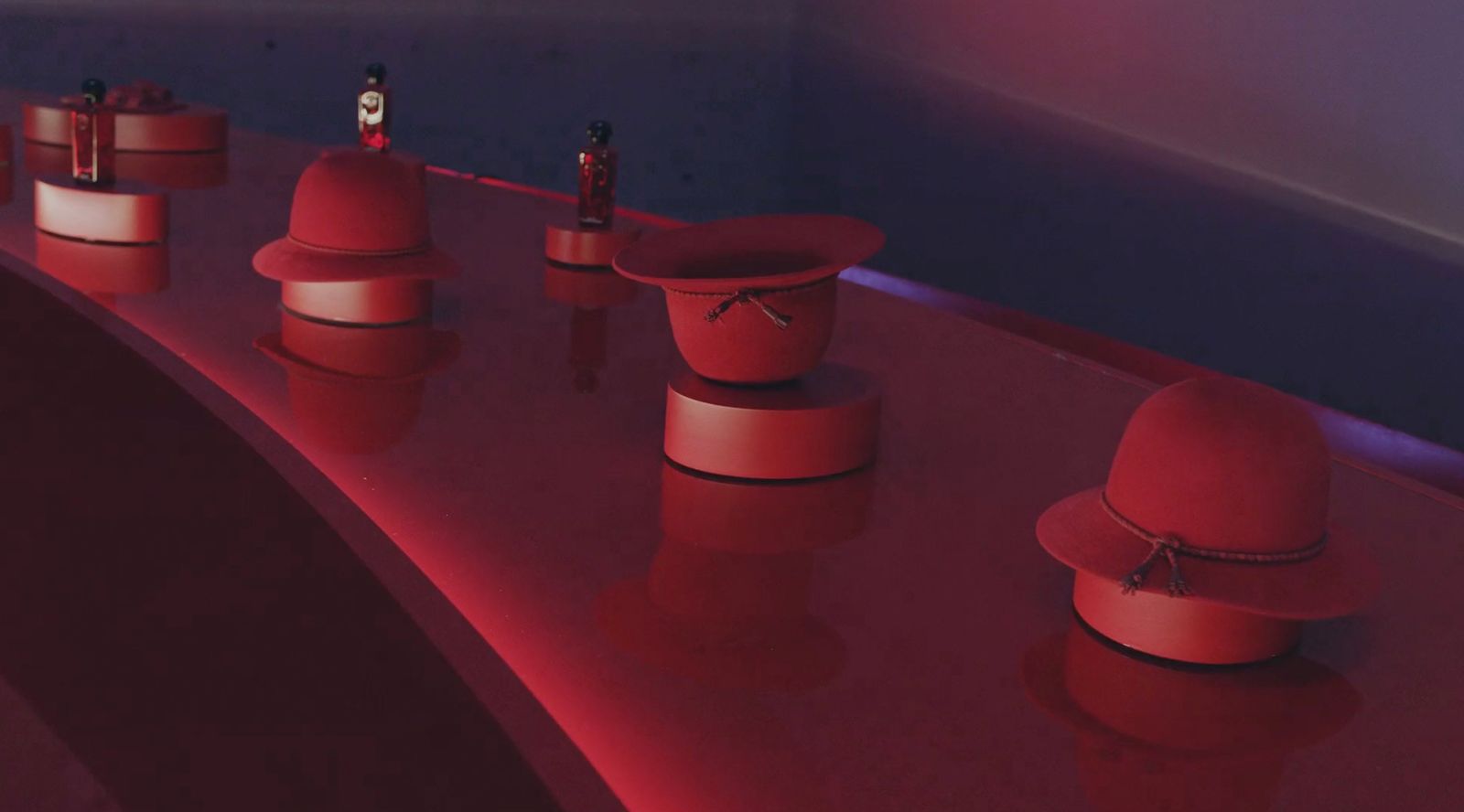 a row of red hats sitting on top of a table