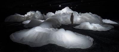 a person standing in front of a pile of snow