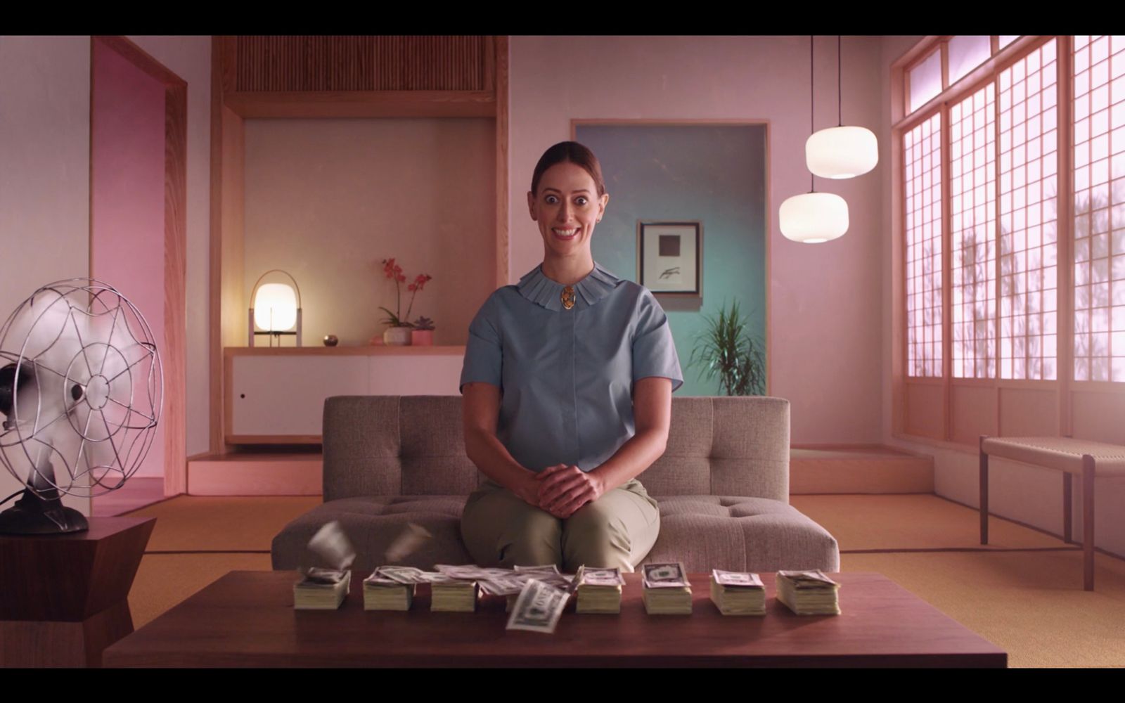 a woman sitting on a couch in a living room