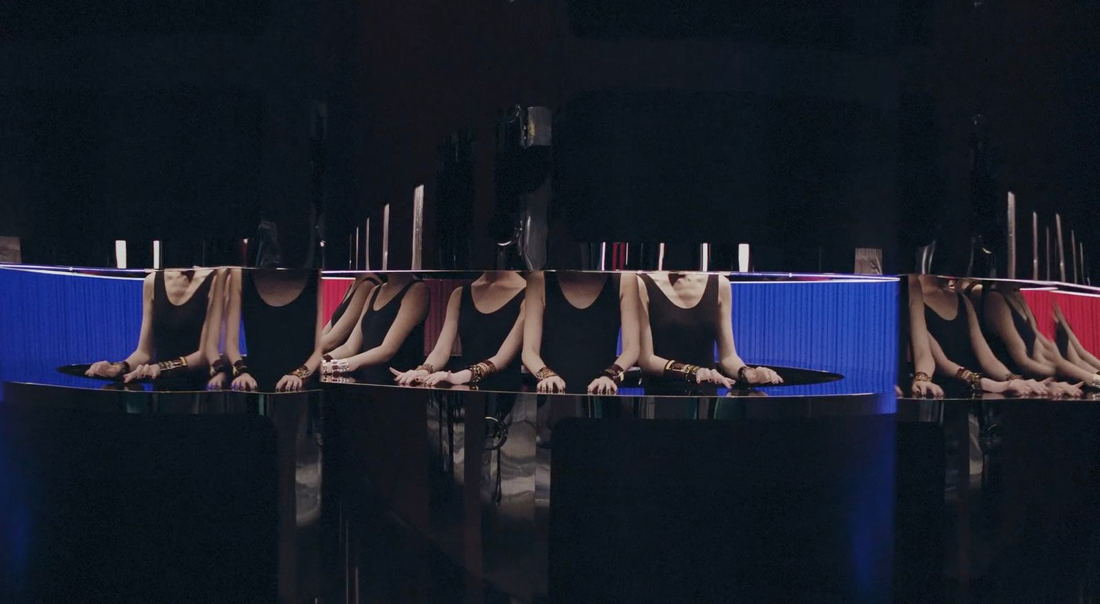 a group of mannequins sitting in front of a mirror