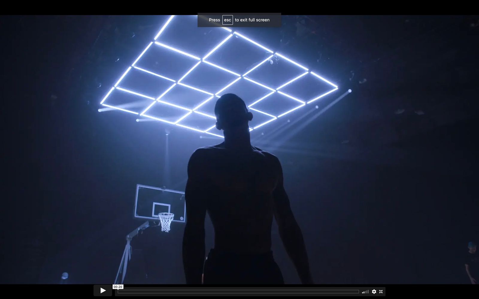 a man standing in front of a basketball hoop