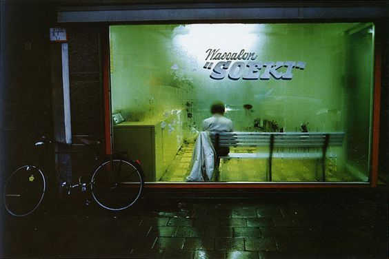 a man standing in front of a store window