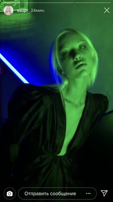 a woman in a dark room with a neon green light