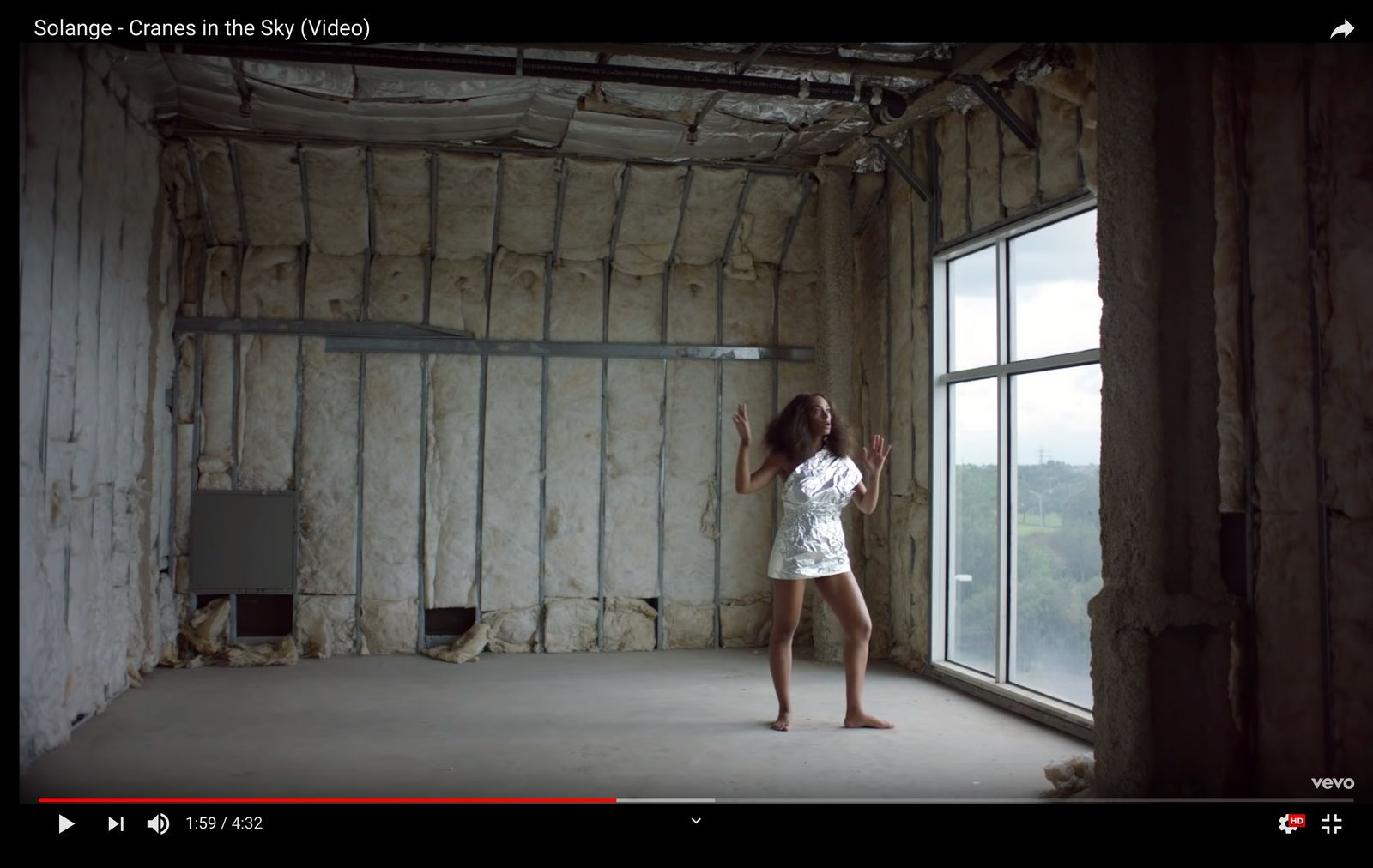 a woman standing in front of a window in a room