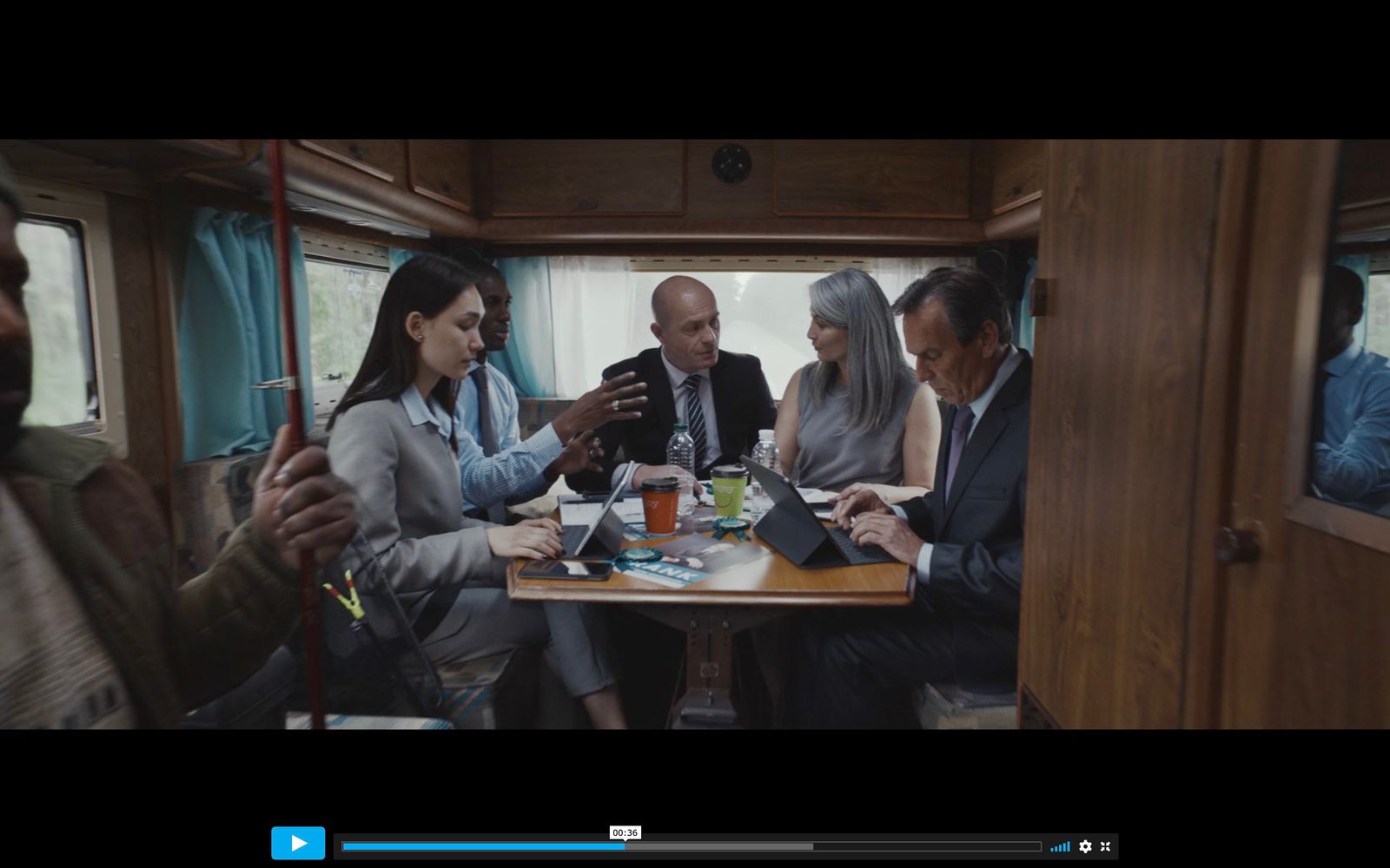 a group of people sitting around a wooden table