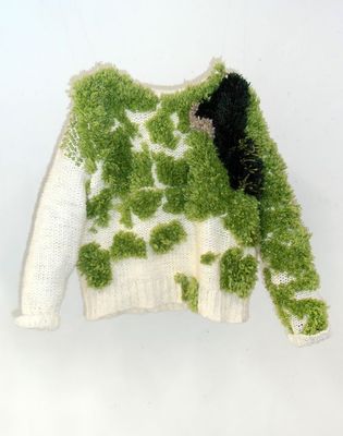 a white sweater with green plants on it