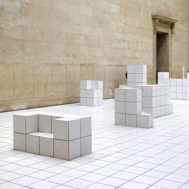 a group of white cubes sitting on top of a white tiled floor