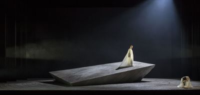 a woman standing on top of a stone structure