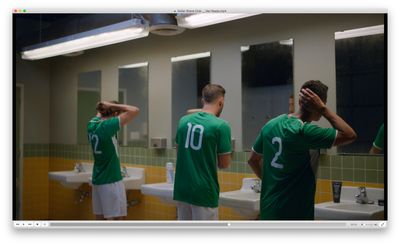 a group of men standing in front of a bathroom mirror