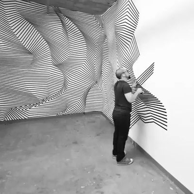 a man standing in front of a wall with an umbrella