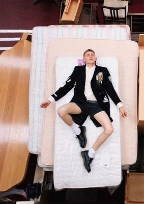 a man laying on top of a mattress in a room