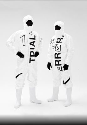 a couple of people in white suits standing next to each other