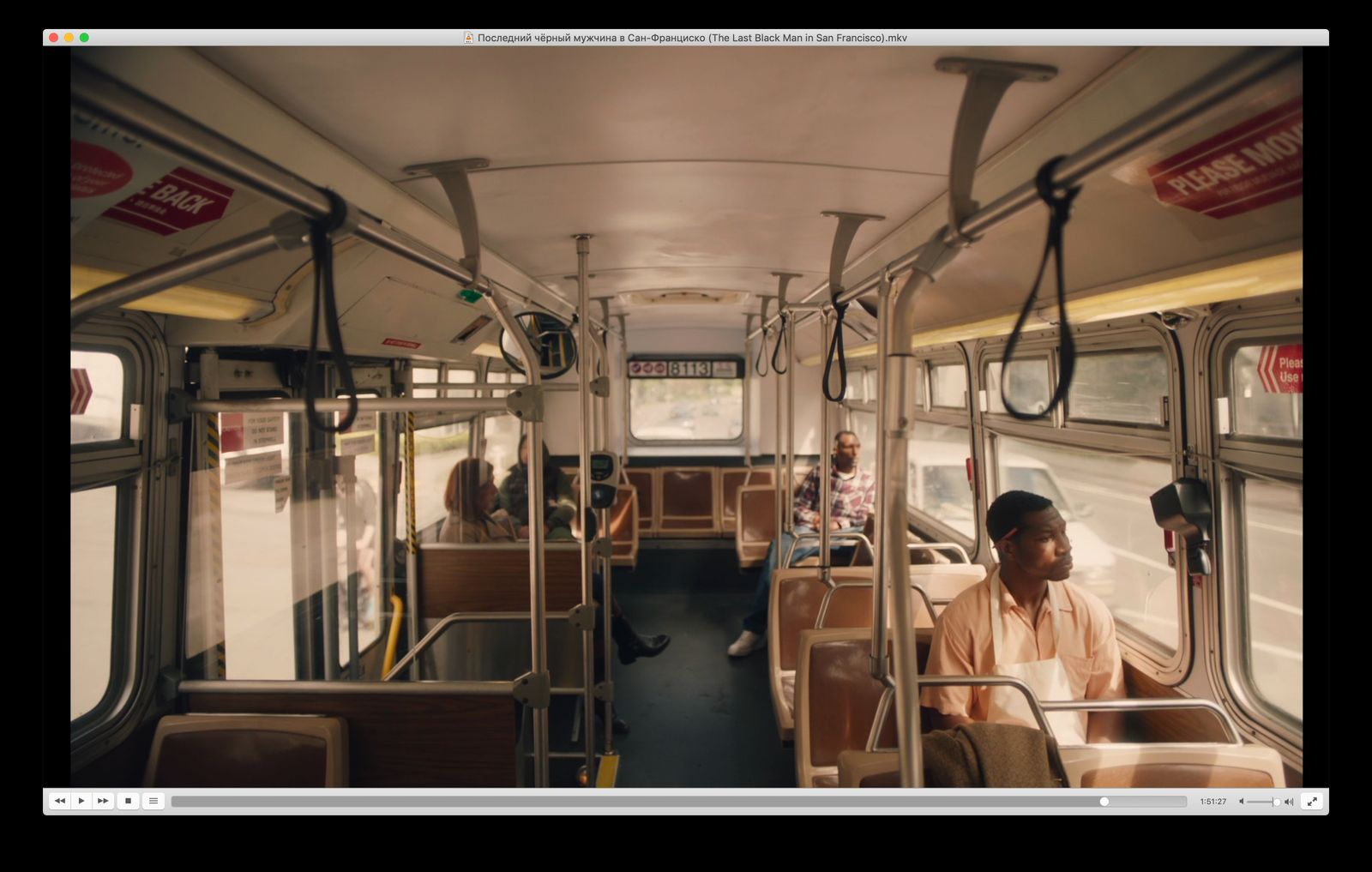 a group of people sitting on a bus next to each other