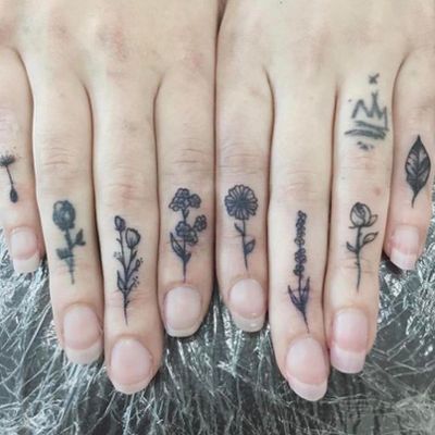 a couple of fingers with tattoos on them