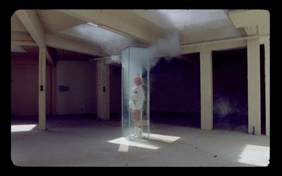 a person in a room with smoke coming out of it