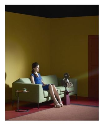 a woman sitting on a couch in a room