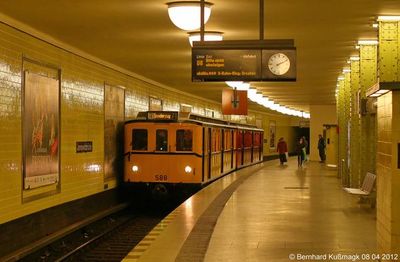 a yellow train pulling into a train station