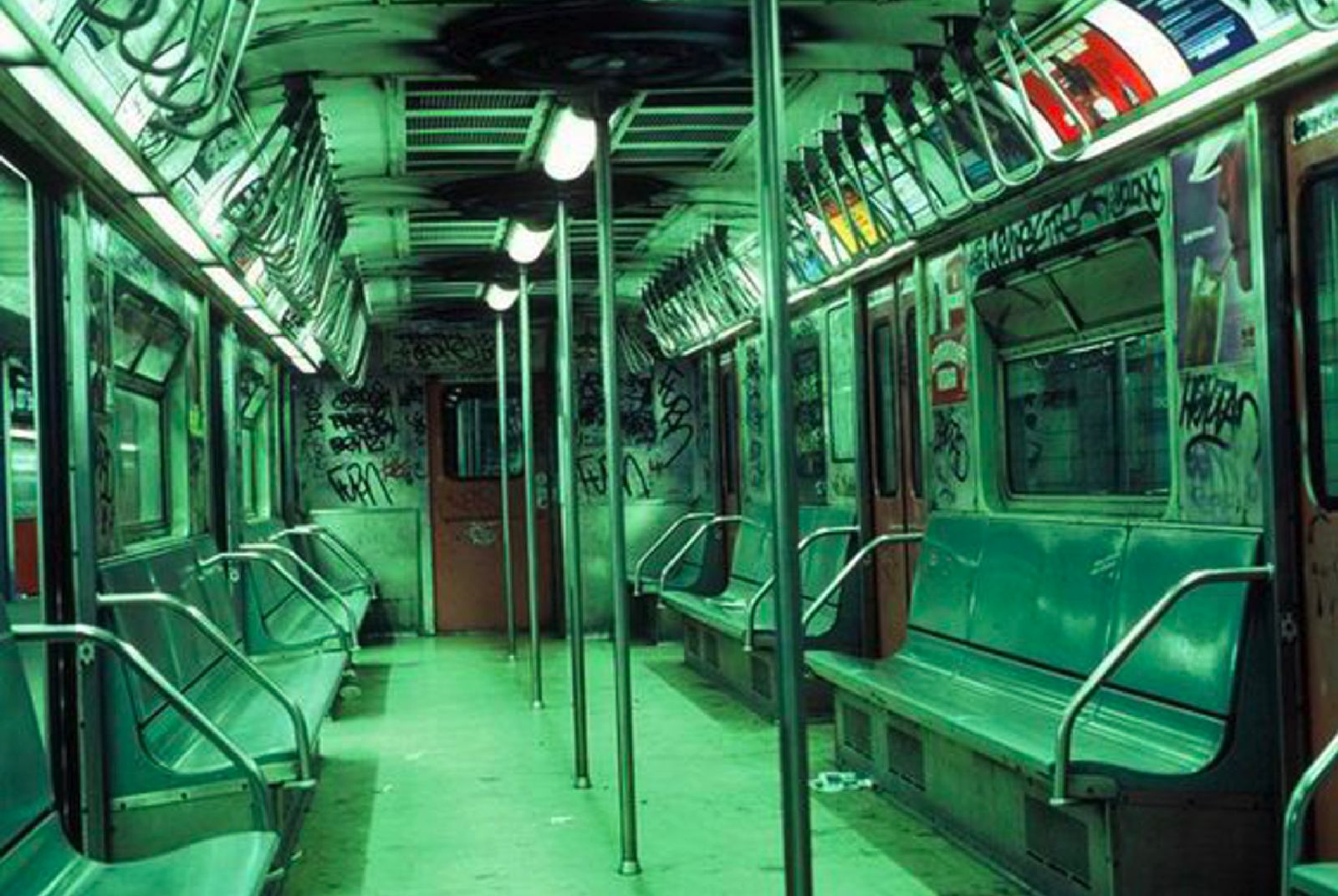 a green subway car with lots of green seats