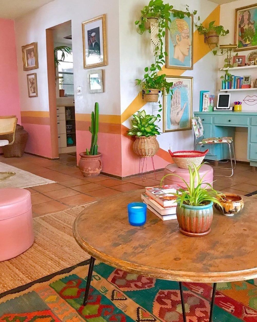 a living room filled with furniture and lots of plants