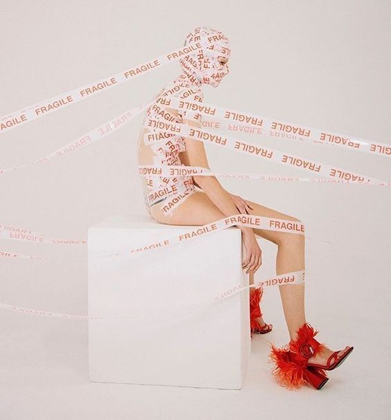 a woman sitting on top of a white box