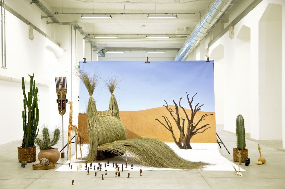 a painting of a desert scene is displayed in a large room