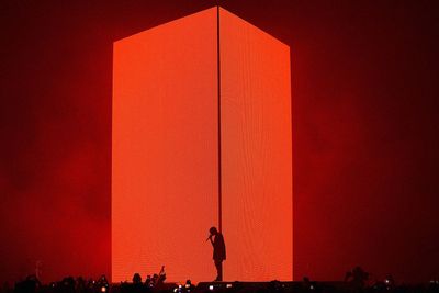 a person standing in front of a giant red object