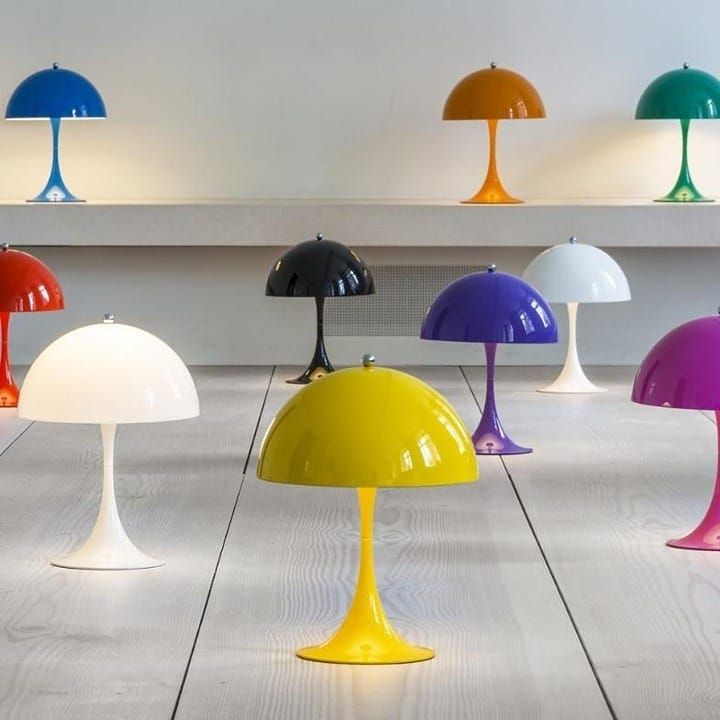 a group of different colored lamps sitting on top of a wooden floor