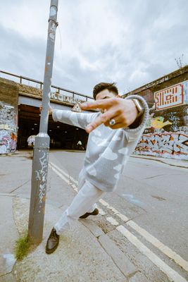 a man is doing a trick on a pole