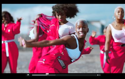 a group of people in red outfits are dancing