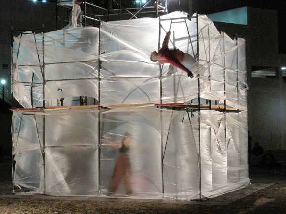 a person on a scaffold in front of a building