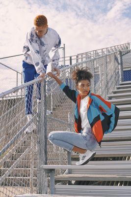 a man and a young girl are on the stairs of a stadium