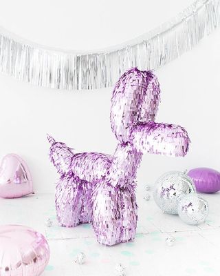 a purple dog balloon sitting on top of a table