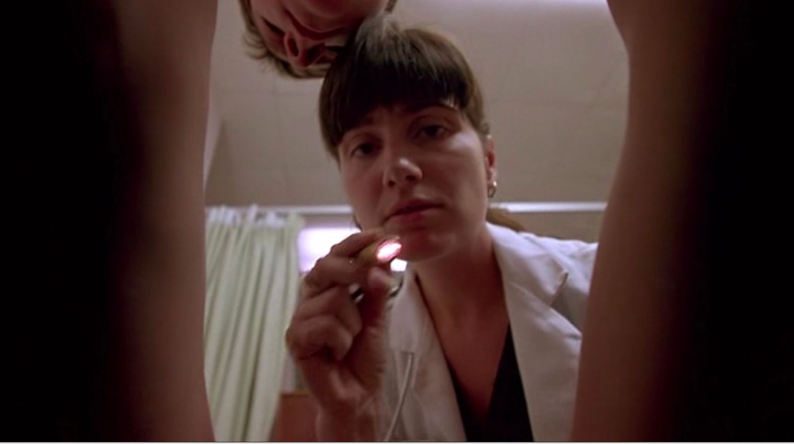 a woman brushing her teeth with a toothbrush