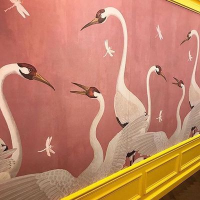 a painting of a group of birds on a wall