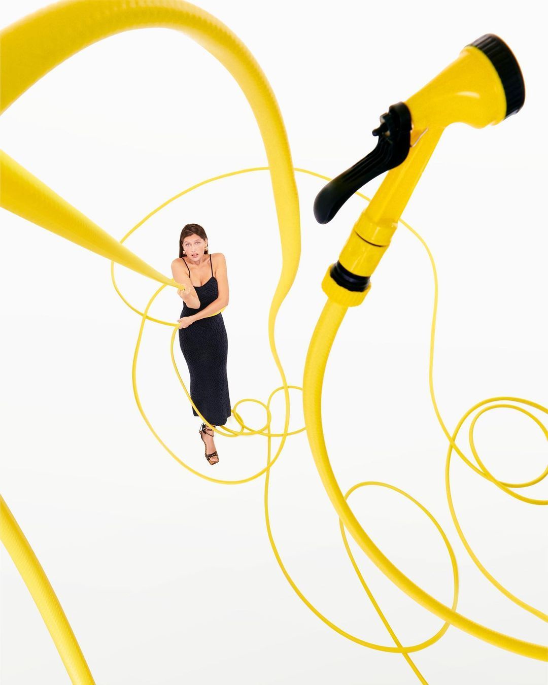 a woman in a black dress and a yellow hose